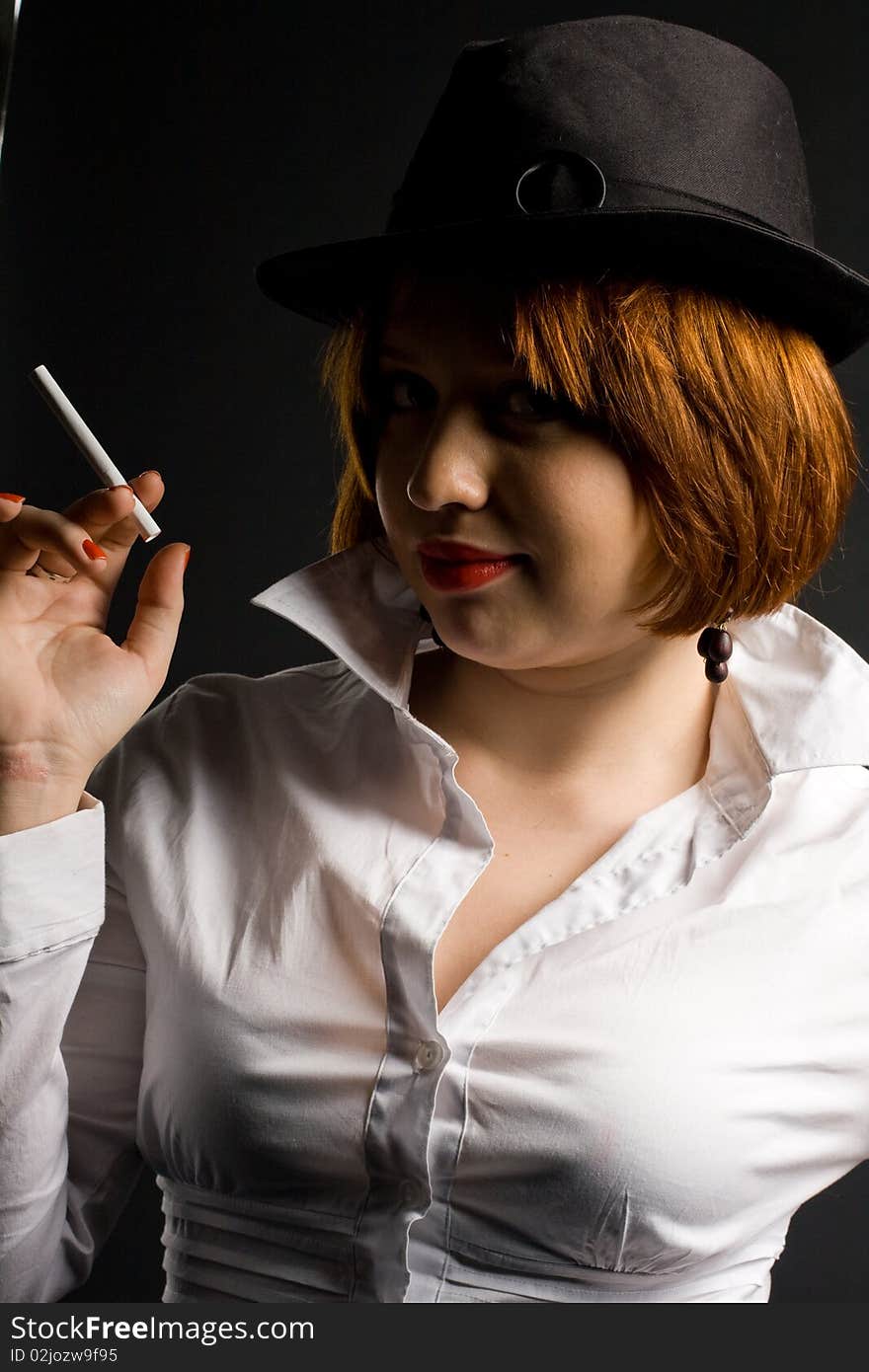 Beautiful girl with cigarette in black hat. Beautiful girl with cigarette in black hat