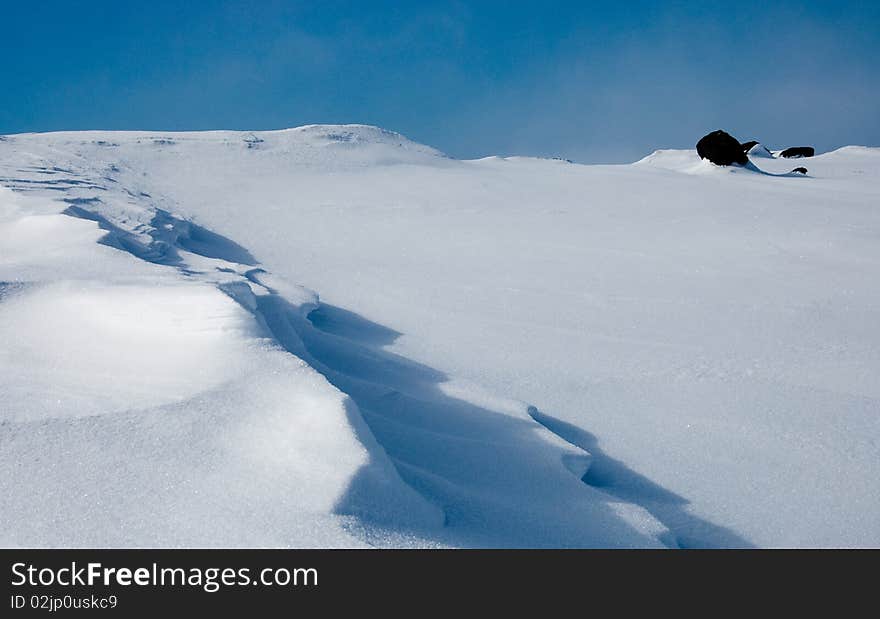 Abstract snow background. It is similar to the sea with floating dolphins. Abstract snow background. It is similar to the sea with floating dolphins