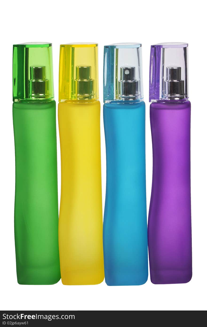 Multi-coloured bottles of female scented water on a white background. Multi-coloured bottles of female scented water on a white background