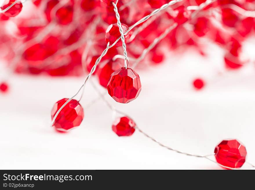 A chain  with red jewels isolated on white. A chain  with red jewels isolated on white