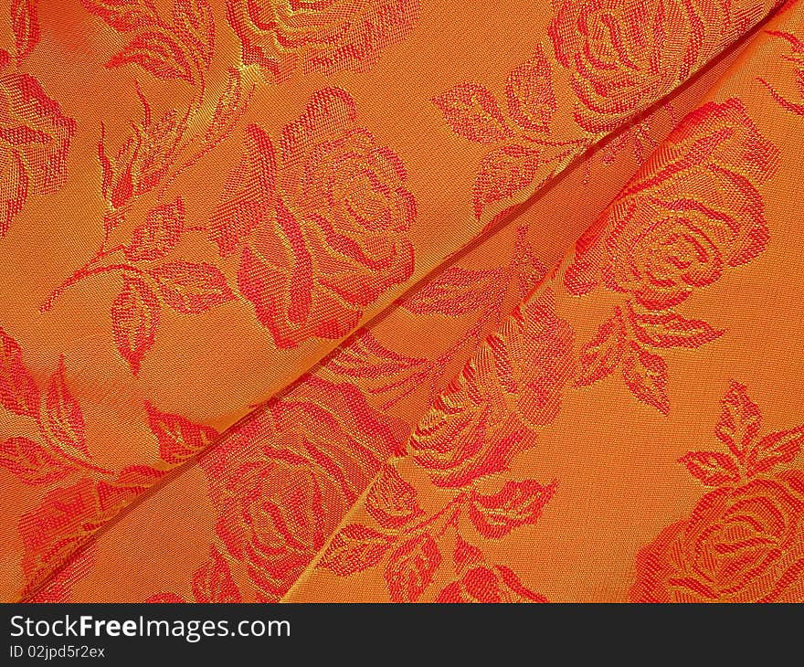 Shiny oramge fabric texture suitable as background. Shiny oramge fabric texture suitable as background