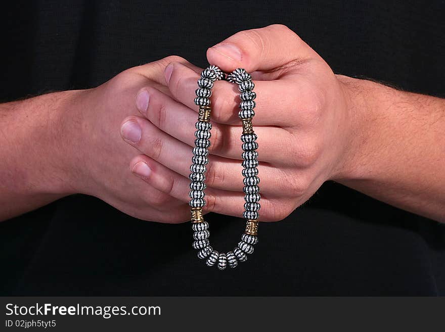 The religion theme, the man has control over rosary from metal.