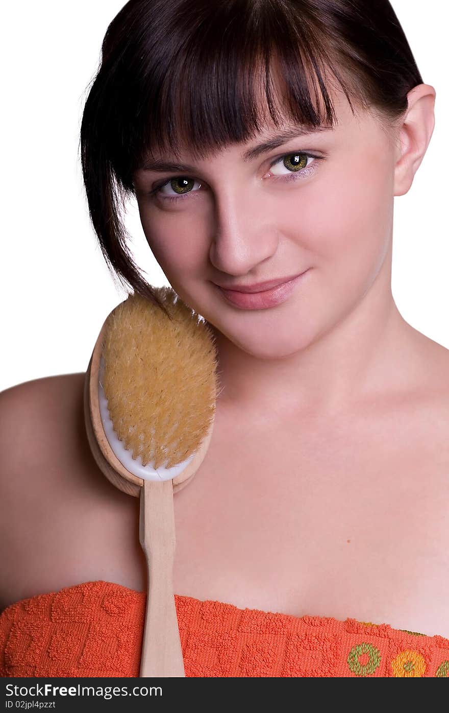 Closeup studio shot of a young beautiful woman with brush for body