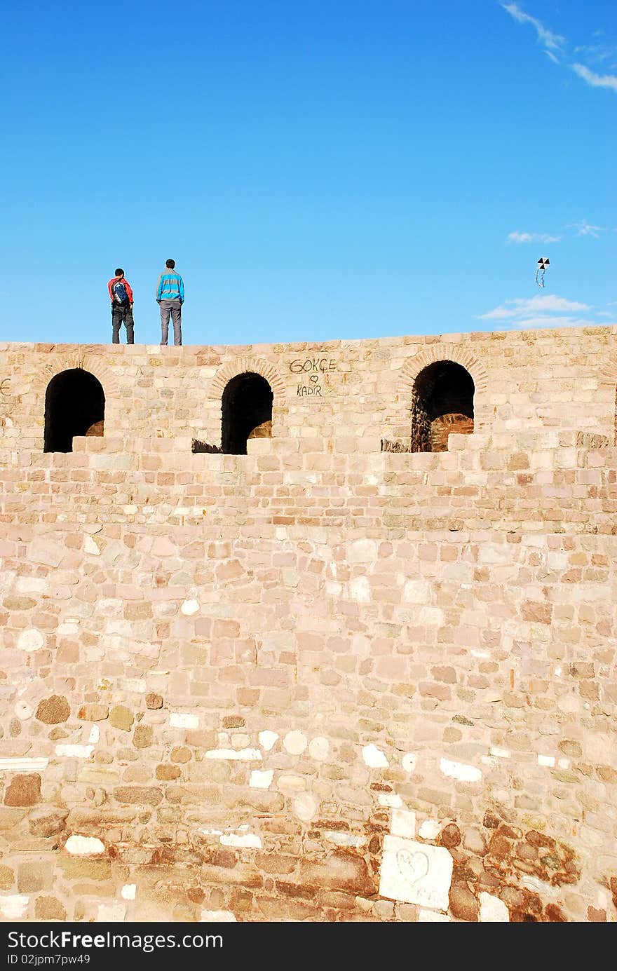 Two men flying kite on the ankara castle