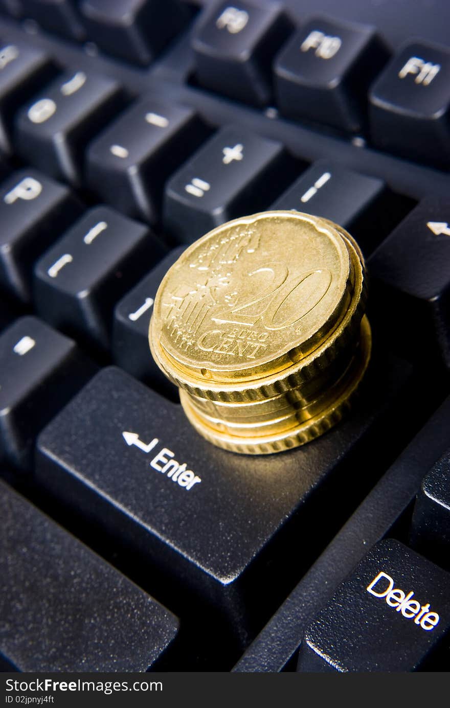 Keyboard with pile of coins. Keyboard with pile of coins