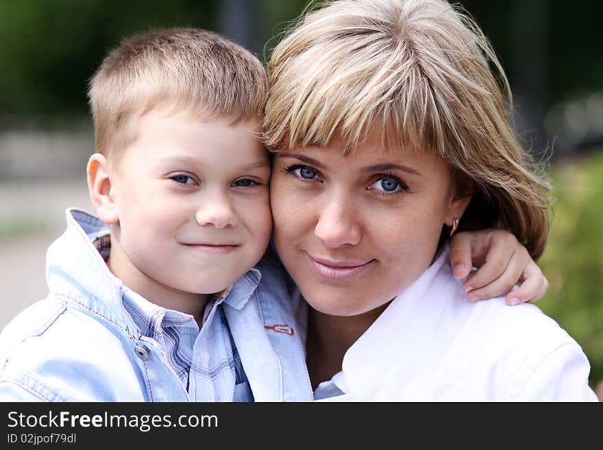 Happy mother and her little son outdoors session