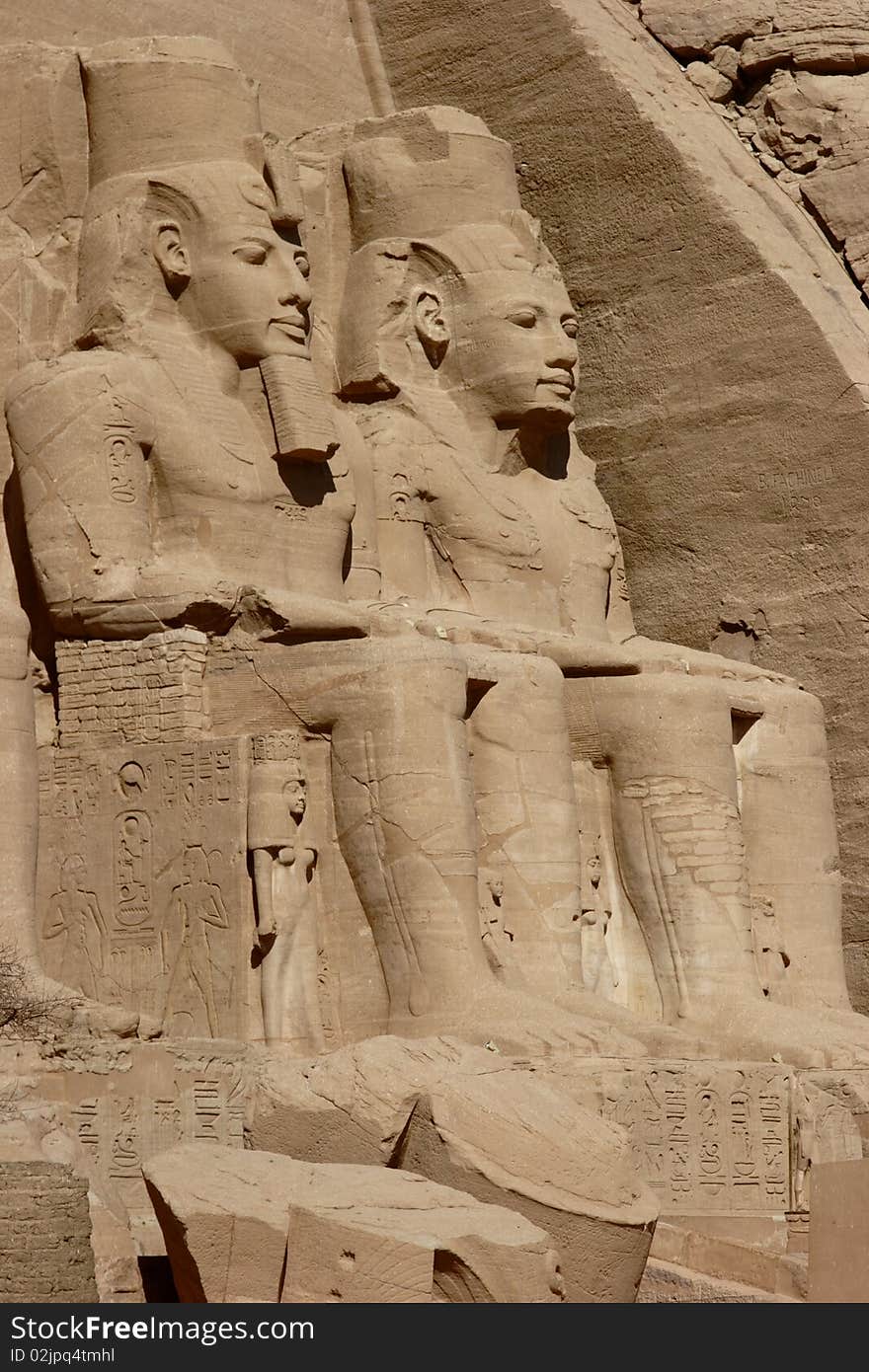 Detail of two colossus at Abu Simbel. Abu Simbel temples are two massive rock temples in Nubia, southern Egypt on the western bank of Lake Nasser about 290 km southwest of Aswan. The complex is part of the UNESCO World Heritage Site known as the Nubian Monuments, which run from Abu Simbel downriver to Philae. Detail of two colossus at Abu Simbel. Abu Simbel temples are two massive rock temples in Nubia, southern Egypt on the western bank of Lake Nasser about 290 km southwest of Aswan. The complex is part of the UNESCO World Heritage Site known as the Nubian Monuments, which run from Abu Simbel downriver to Philae