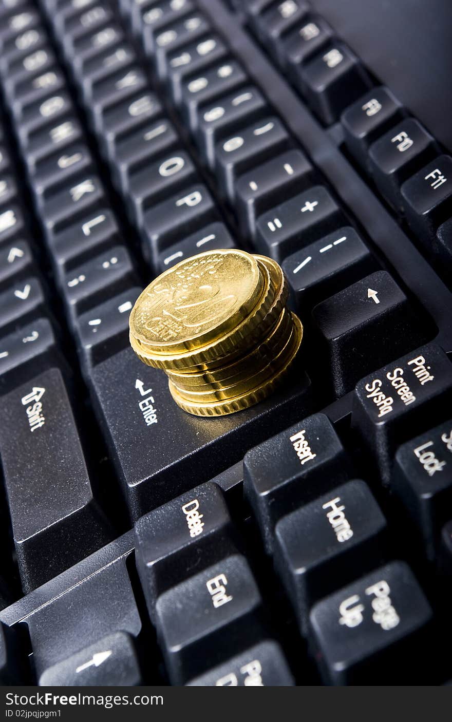 Line of coins on keyboard. Line of coins on keyboard