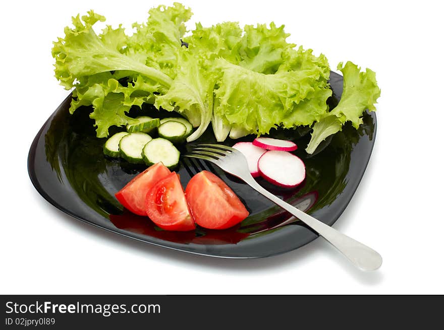 Fresh cucumber, radish, tomatoes and Lettuce on black plate. Vegetarian diet. Fresh cucumber, radish, tomatoes and Lettuce on black plate. Vegetarian diet.