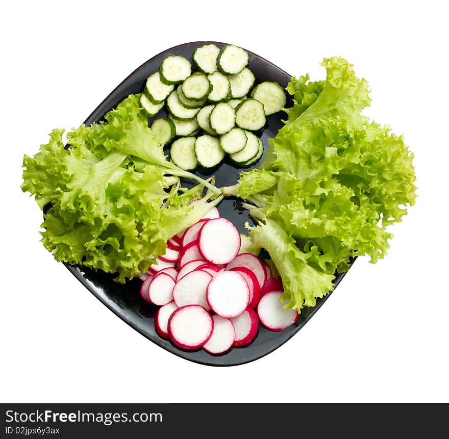 Fresh cucumber, radish and Lettuce on black plate isolated on white