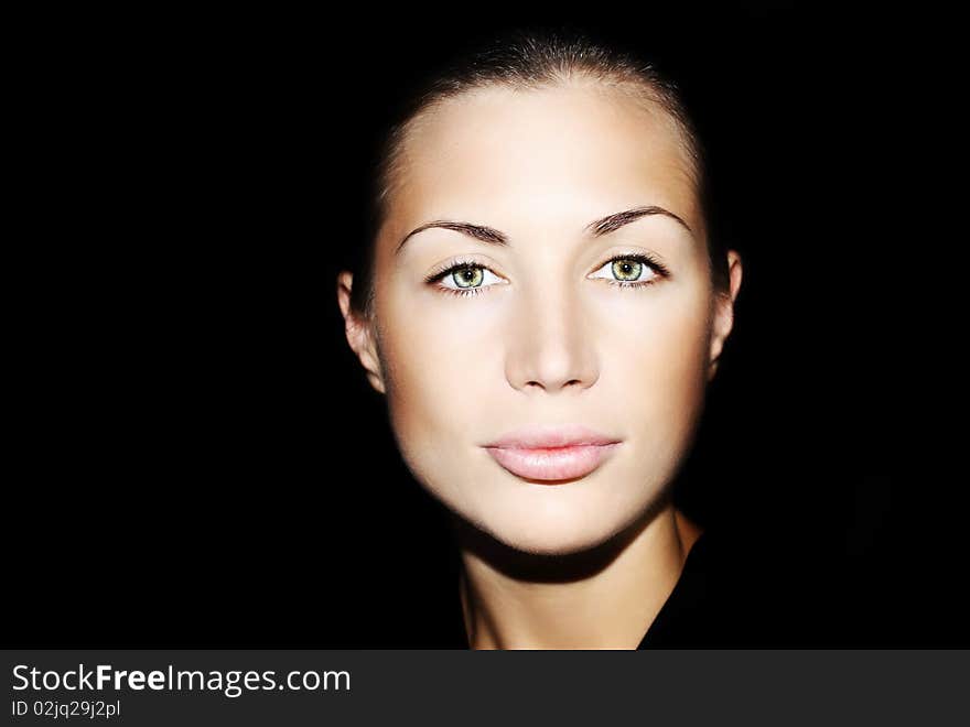 Portrait of a beautiful young lady over black background. Portrait of a beautiful young lady over black background