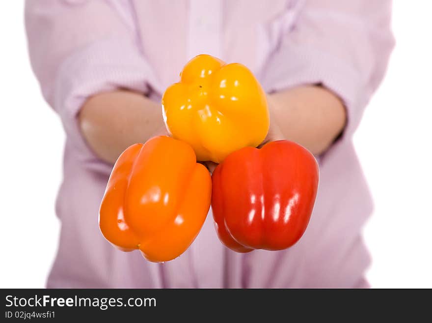 Woman holds three peppers, orange, red and yellow, all isolated on white. Woman holds three peppers, orange, red and yellow, all isolated on white