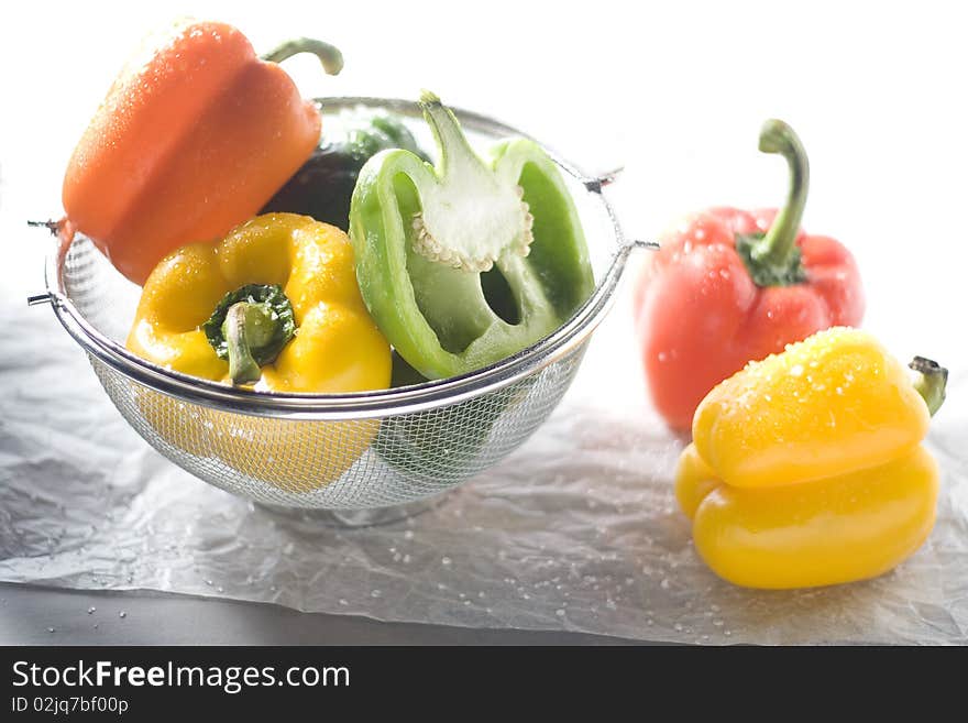 Highkey shot of yellow, red and green bell peppers.