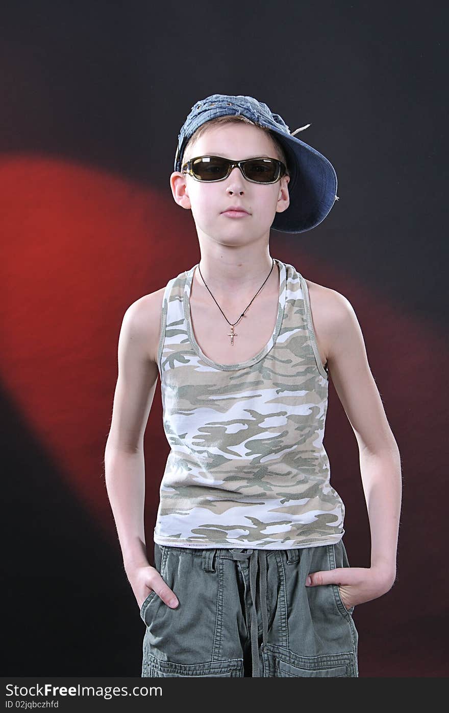 Ten years old boy in a jean cap and sun glasses