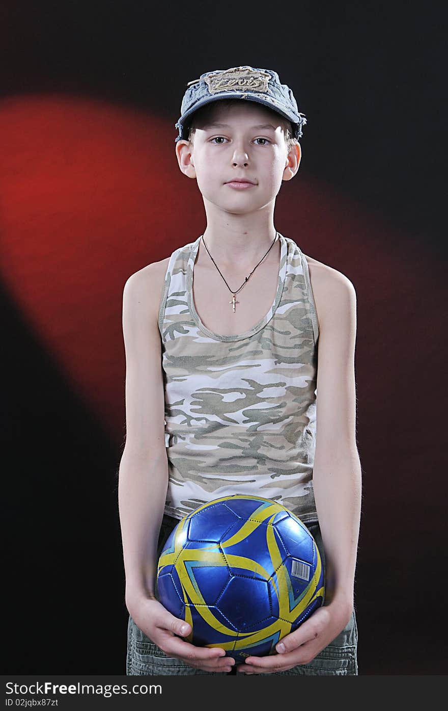 Boy of ten years with a ball in hands