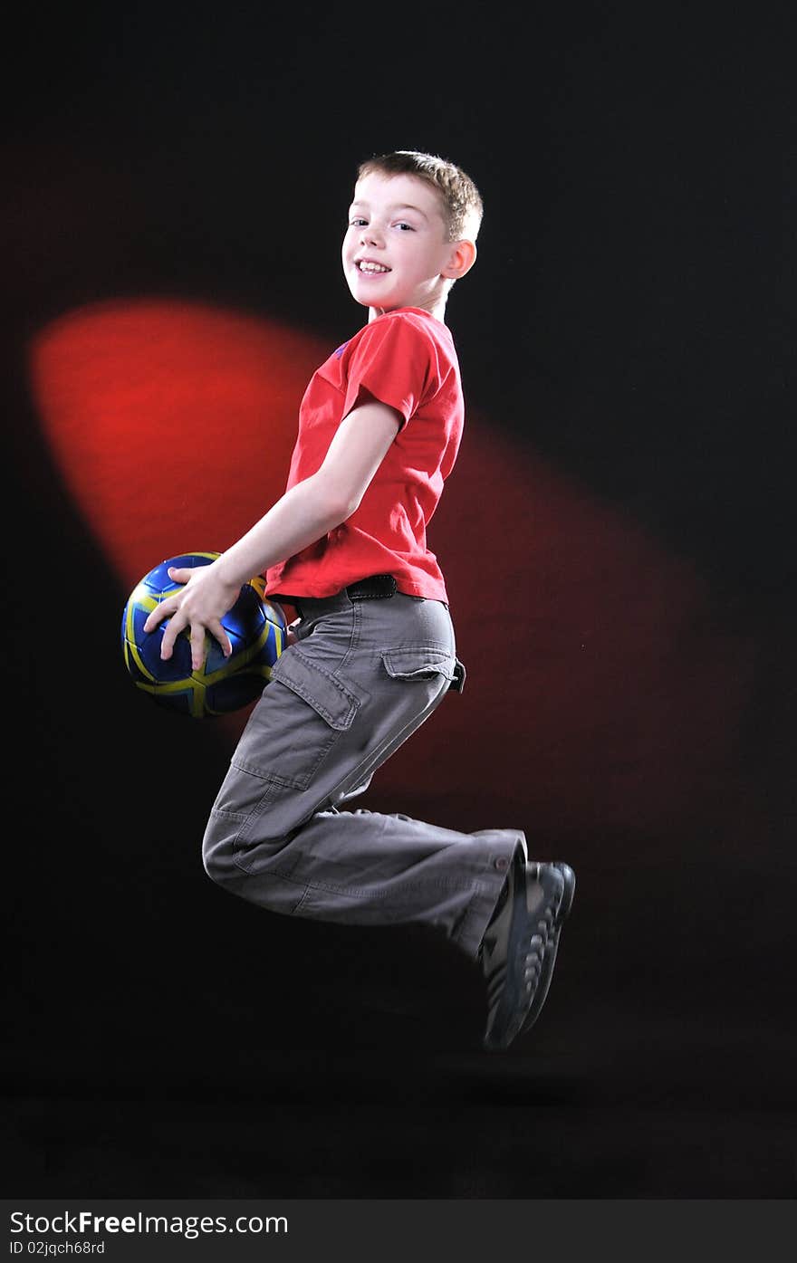 Boy in jump catches a soccer ball