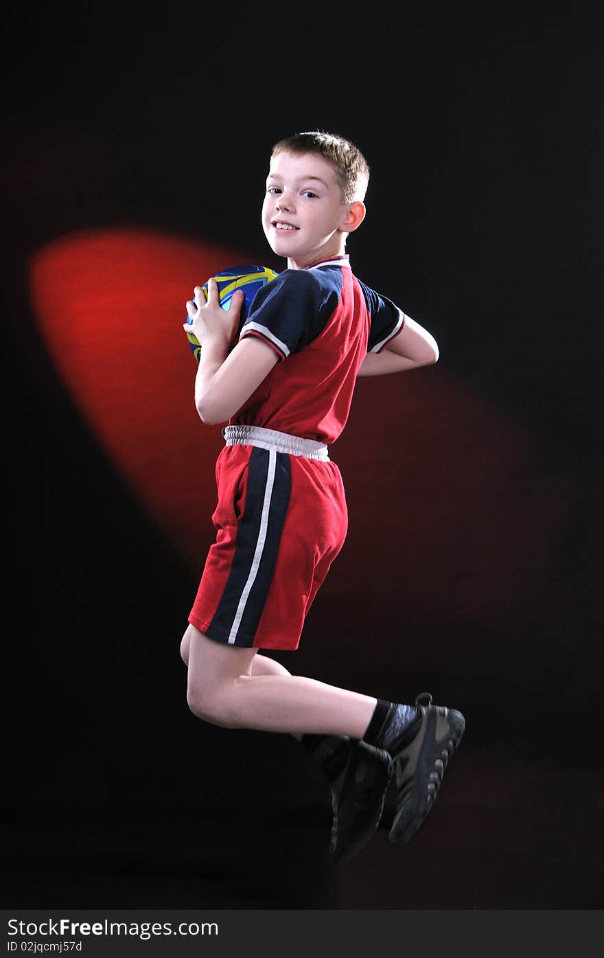 Boy in jump catches a soccer ball