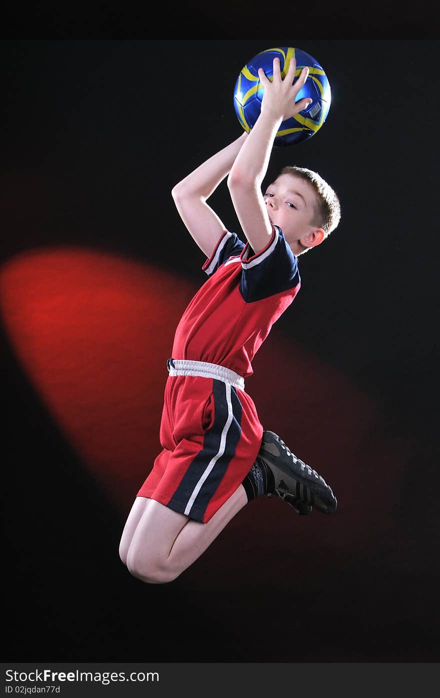 Boy In Jump Catches A Soccer Ball