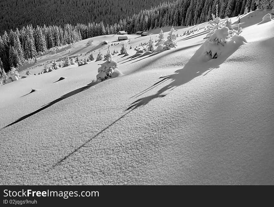 Snow in a mountain landscape with a small house