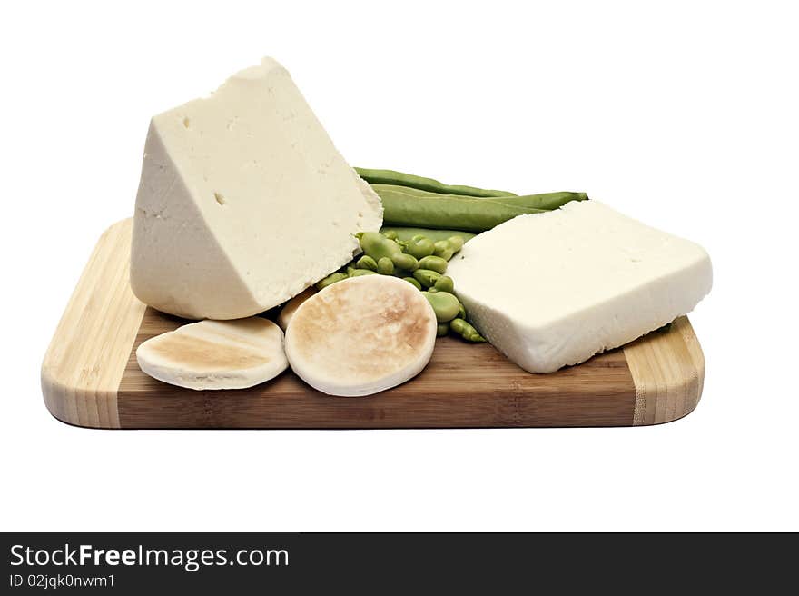 Beans and cheese on a cutting board is a white background. Beans and cheese on a cutting board is a white background