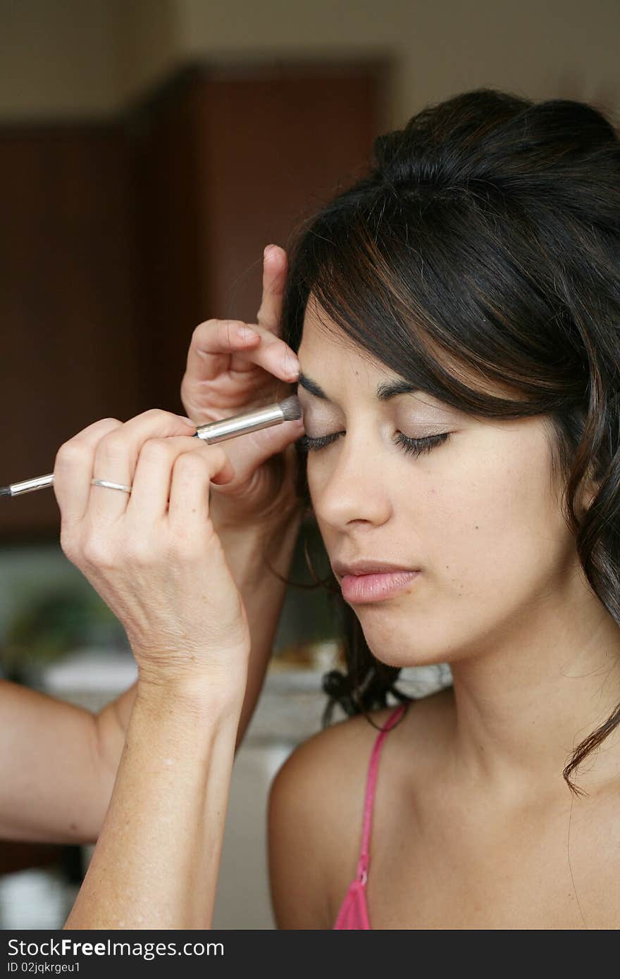 Attractive young brunette woman having make up put on, eyeshadow. Attractive young brunette woman having make up put on, eyeshadow