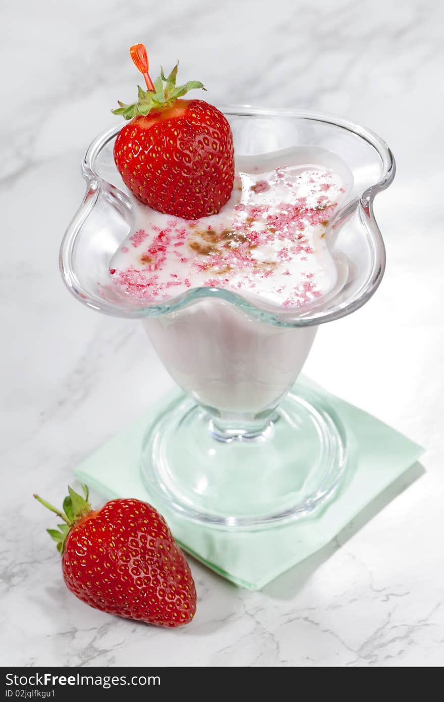 Milk shake with fresh strawberries on white table top. Milk shake with fresh strawberries on white table top