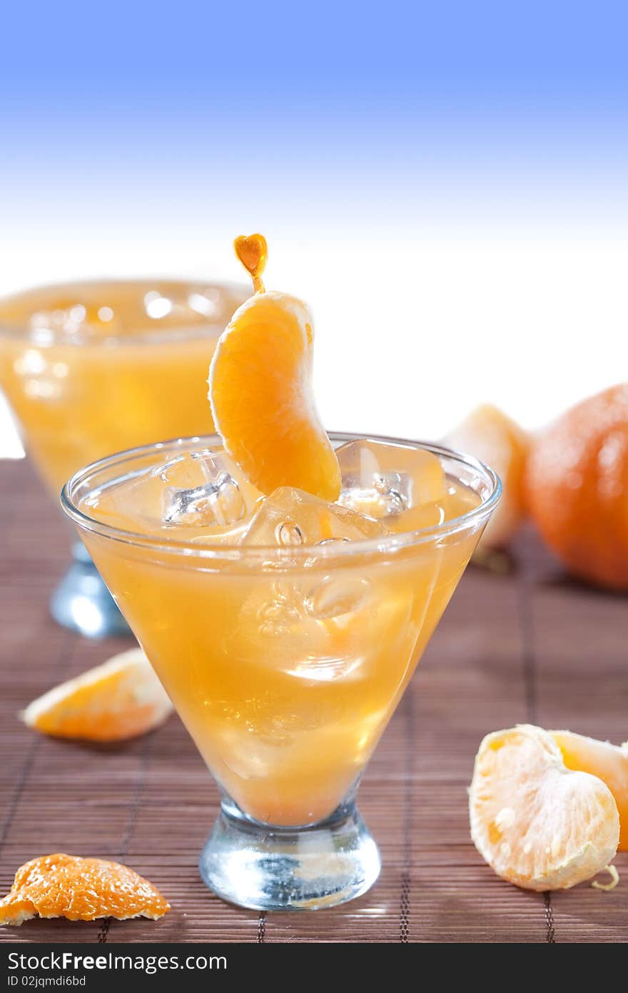 Glass of ice cold beverage with tangerine fruits. Glass of ice cold beverage with tangerine fruits