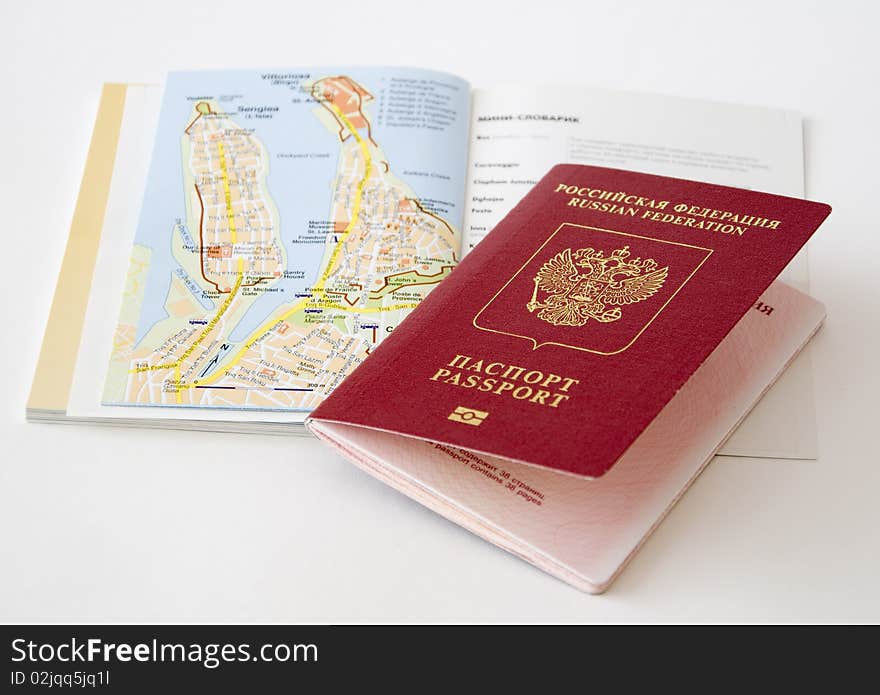 The Russian passport lies on a map of the city