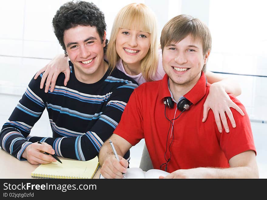 The group of students smiles looking at the camera