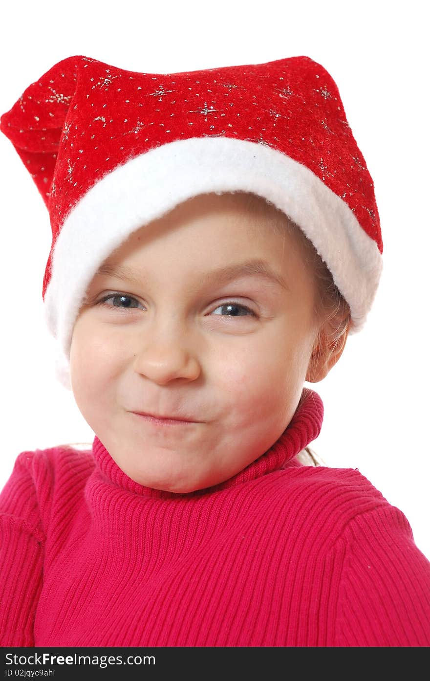 Funny face of child wearing red Santa�s hubcap.