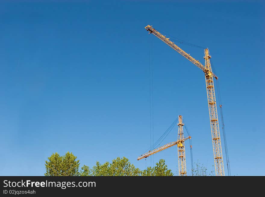 Two hoisting cranes and the sky