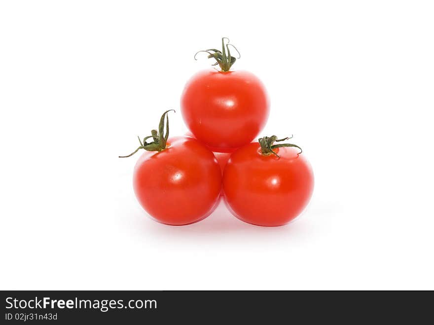 Red and fresh tomatoes on a white background. Red and fresh tomatoes on a white background