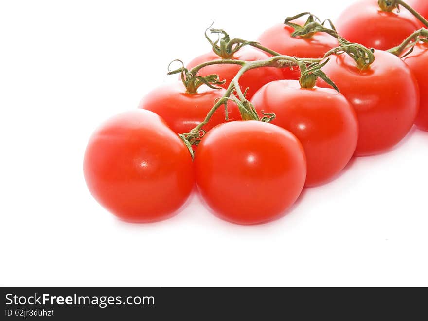 Red and fresh tomatoes on a white background. Red and fresh tomatoes on a white background