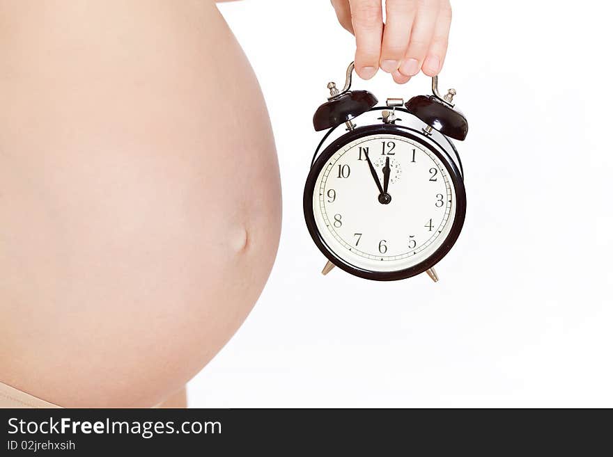 It's time! Pregnant woman's belly with clock