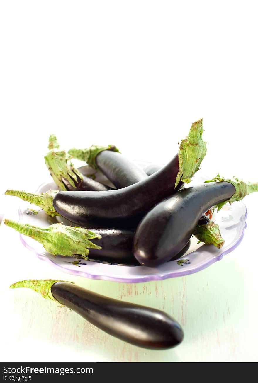 Fresh eggplants on the plate