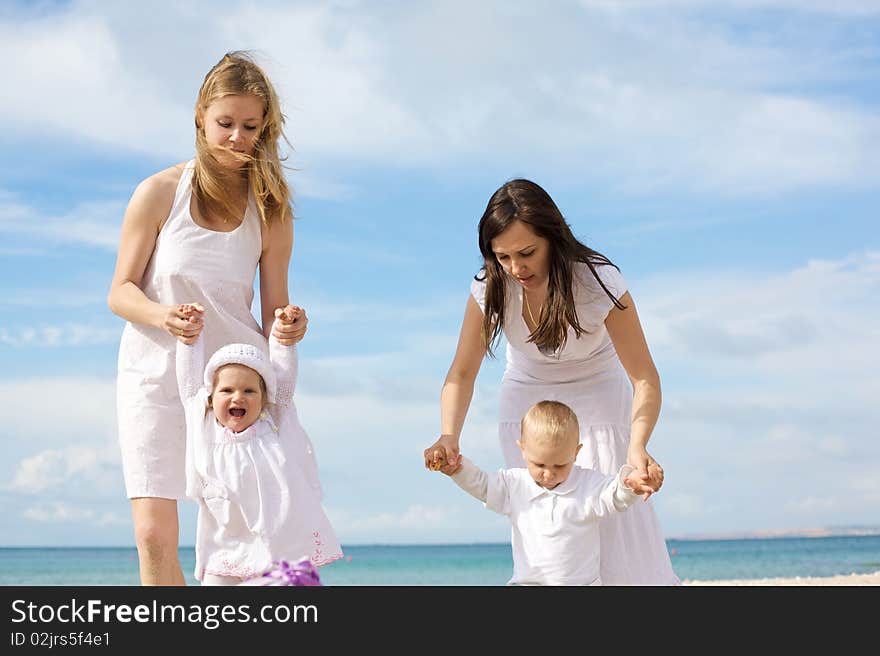 Happy mothers with children at the beach