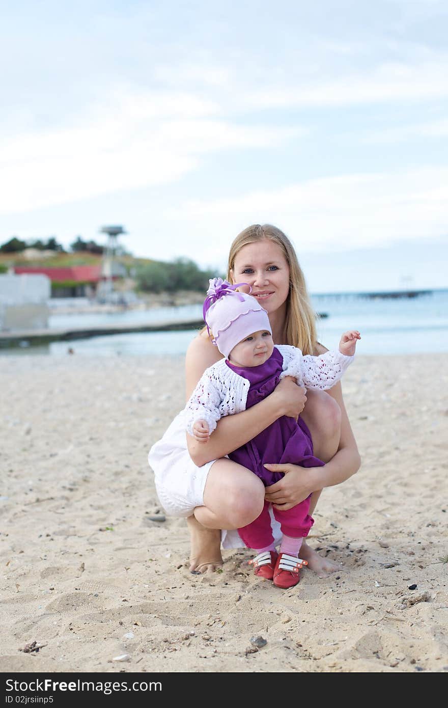 Happy mothers with children at the beach on leave