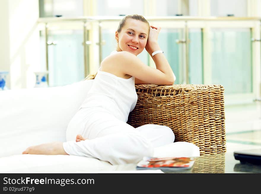 Happy young woman in white at home