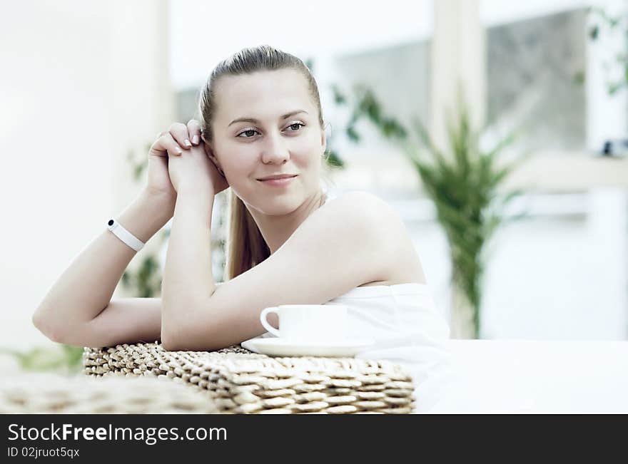 Happy young woman in white at home