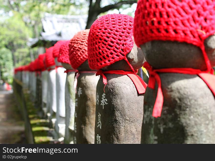 Figure of Buddha doll Japan religion red hat shrine