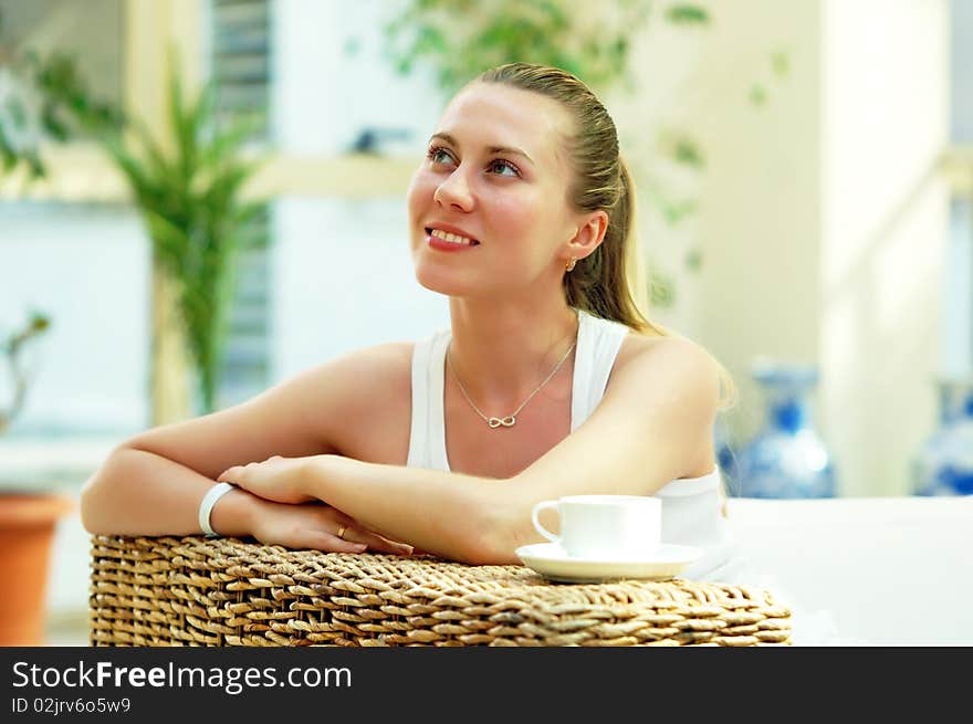 Happy young woman in white at home