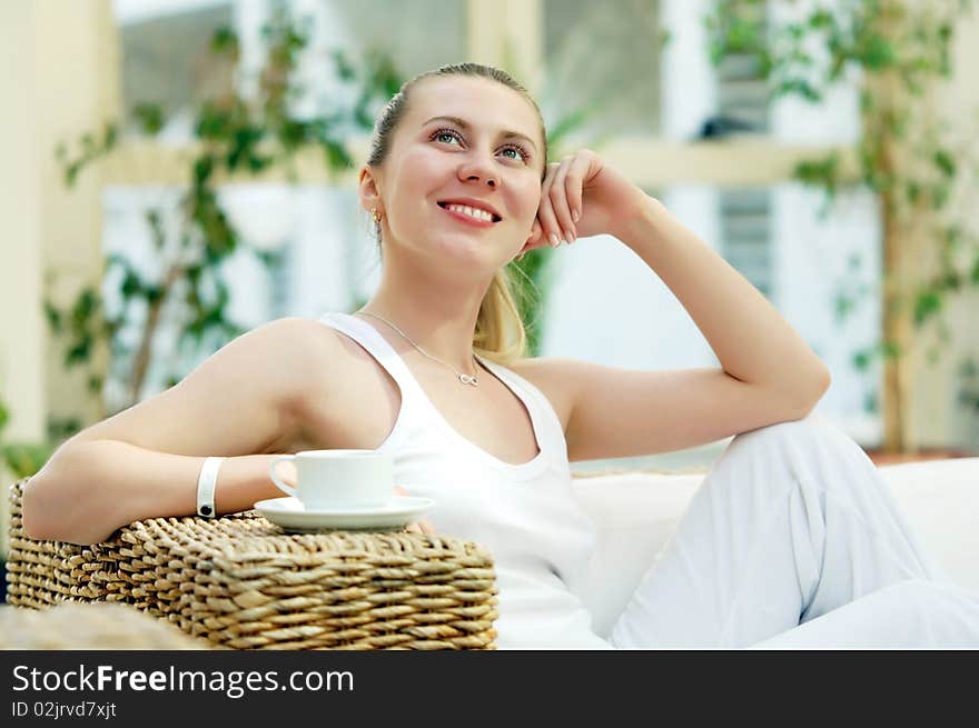 Happy young woman in white at home