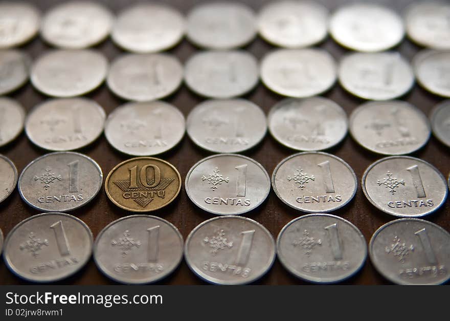 Close-up background made of lithuanian coins, one of them is different from the other. Close-up background made of lithuanian coins, one of them is different from the other