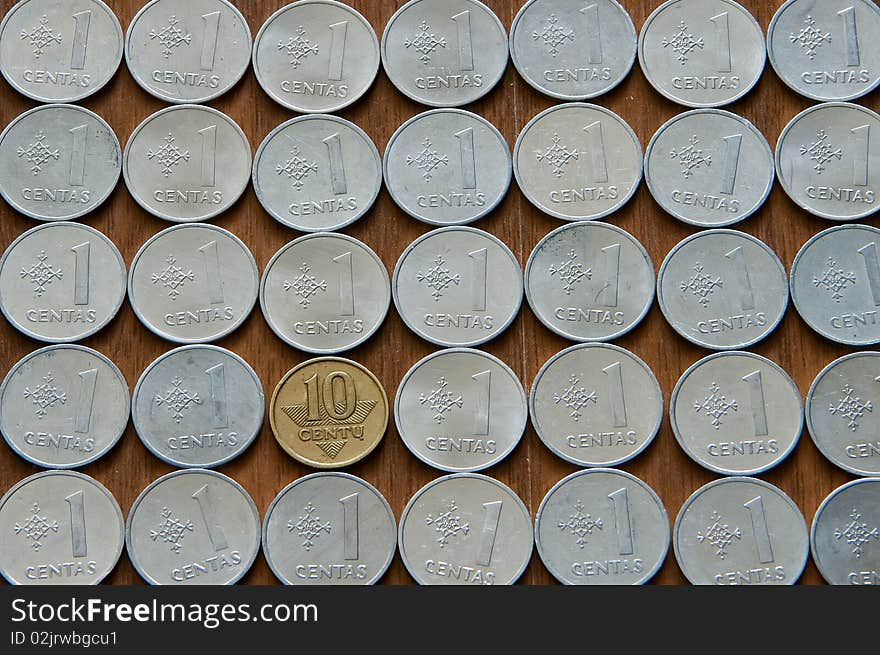 Background made of lithuanian coins, one of them is different from the other. Background made of lithuanian coins, one of them is different from the other