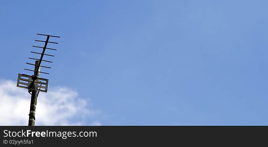 A Metal Television aerial against a blue sky. A Metal Television aerial against a blue sky.