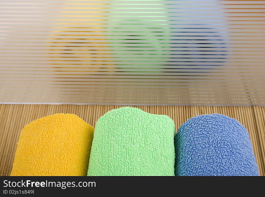 Colored towels are folded to lie near. reflection. Colored towels are folded to lie near. reflection