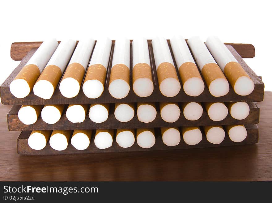 It is a lot of cigarettes on a support on a white background bad