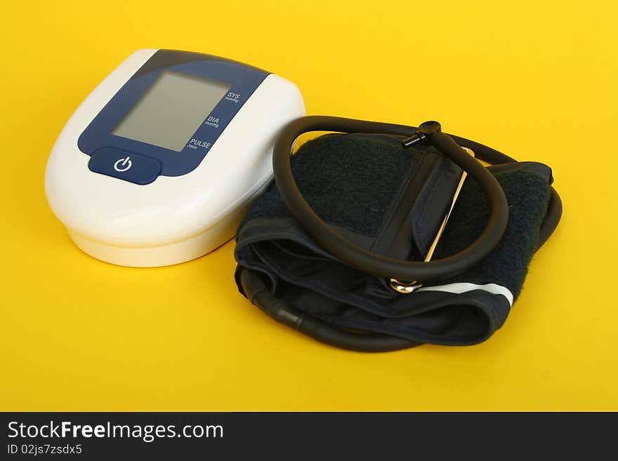 Equipment of measuring blood pressure isolated on yellow background