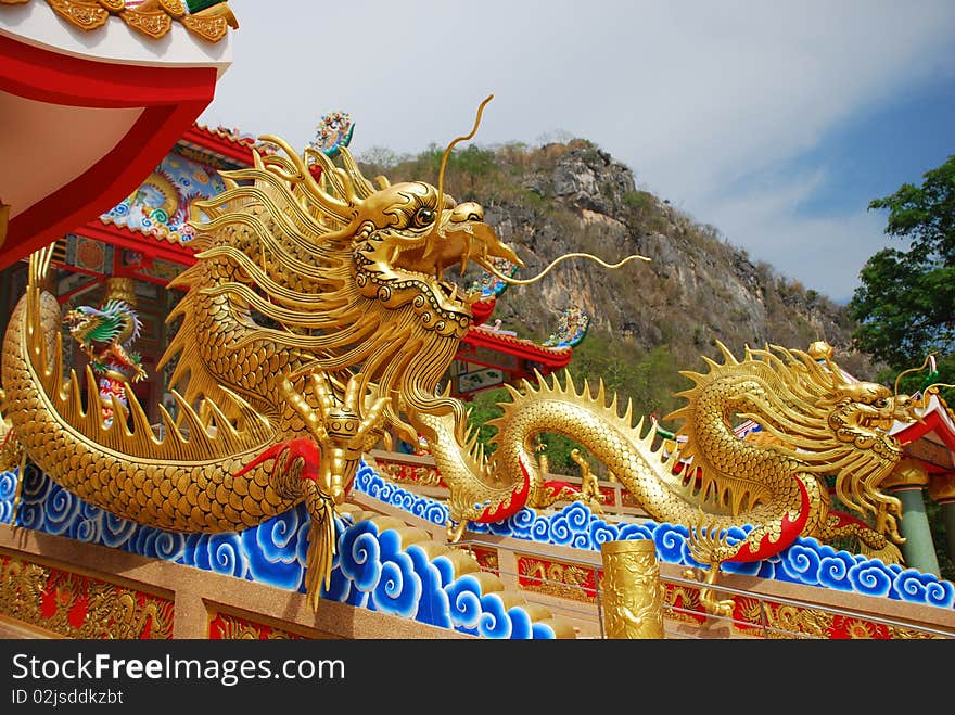 Gold  dragons at  Chinese temple in mountain. Gold  dragons at  Chinese temple in mountain.