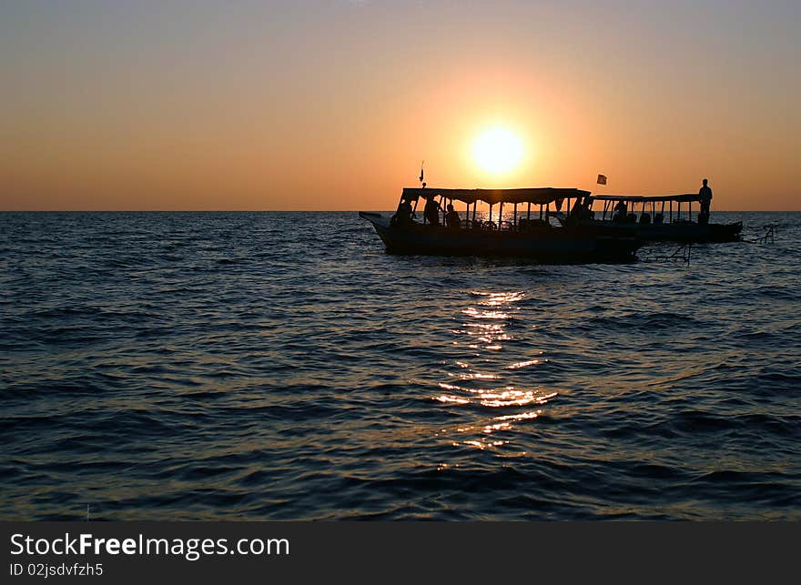 Ocean with its viewers against the sunset. Ocean with its viewers against the sunset.